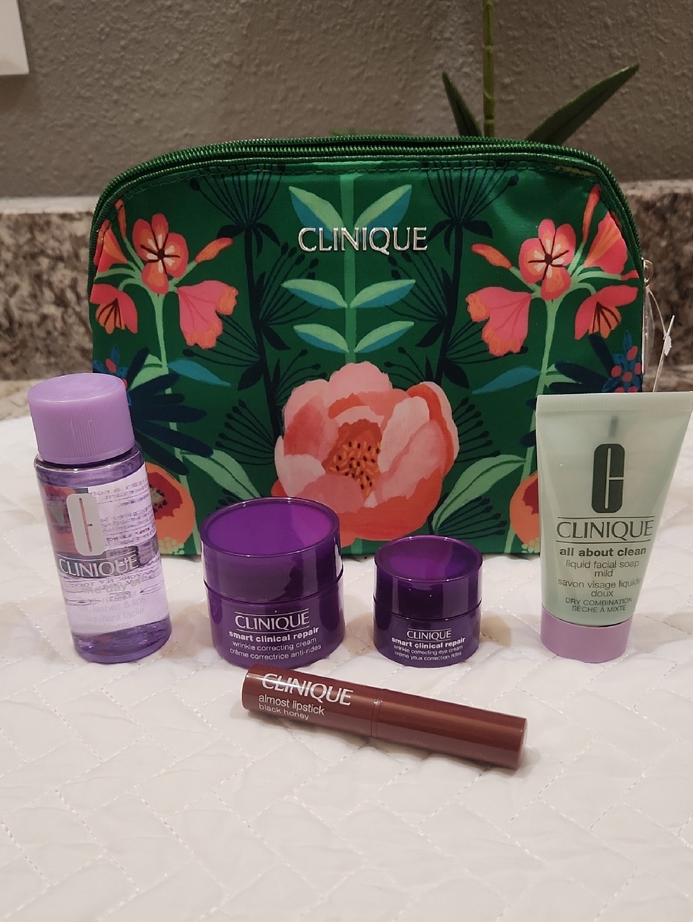 Clinique Green Floral Travel Pouch with Skincare & Black Honey Almost Lipstick.